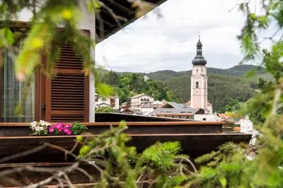 a view of a town with a church tower at Apartments Sayonara in Castelrotto
