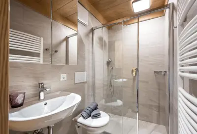 a bathroom with a sink and a shower at Apartments Sayonara in Castelrotto