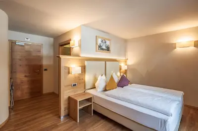 a bedroom with a large bed in a room at Albergo Belvedere in Vigo di Fassa
