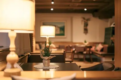a table with a lamp on top of it at Albergo Belvedere in Vigo di Fassa