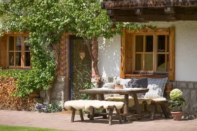 a table and chairs in front of a house at Villa al Bosco in Selva di Val Gardena