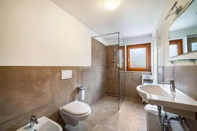 a bathroom with a sink and a toilet and a shower at Oberkapillhof in Meltina