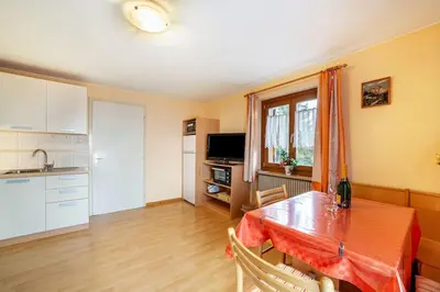 a kitchen with a table with a red table cloth on it at Oberkapillhof in Meltina