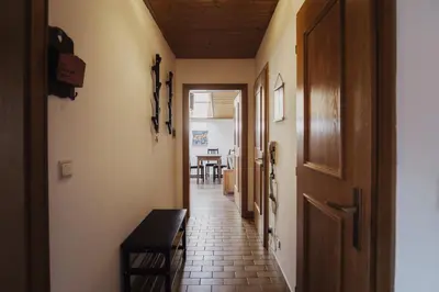 a hallway with a door and a table at Töllhof Apartments and Farm in Naz-Sciaves