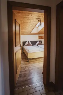 a bedroom with a bed in a room with a ceiling at Töllhof Apartments and Farm in Naz-Sciaves