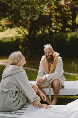 a man and a woman sitting on a bench at Villa Gloria in Soprabolzano
