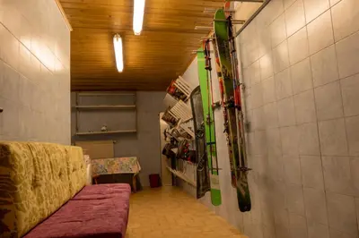 a room with skis hanging on a wall at Villa Artic Apartments in Campitello di Fassa