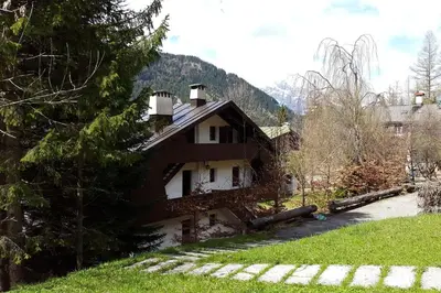 a house with a mountain in the background at Mansarda a San Vito di Cadore in San Vito di Cadore