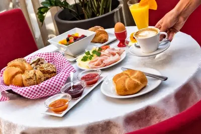 a table with breakfast foods and a cup of coffee at Appartement Wiere in Molini di Tures
