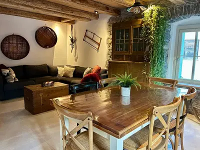 a living room with a wooden table and a couch at Appartamenti La Rocia in Rocca Pietore