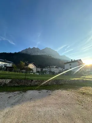 a water hose is spraying into a field with houses at CASA VACANZE MIRAMONTI - appartamento con balcone con vista sulle Dolomiti in Borca di Cadore