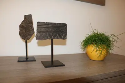 a couple of statues on a table with a plant at Appartment Larcher - Meinhard in Merano
