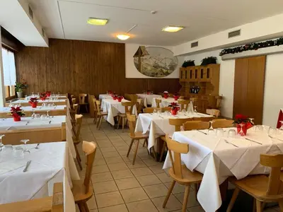 a dining room with chairs and a table and a table and chairs at Villa Ombretta in Soraga