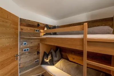 a room with three bunk beds and a shower at Rodererhof in Laion