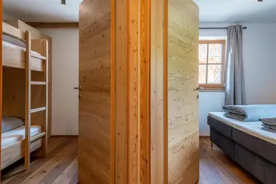 a room with two bunk beds and a closet at Rodererhof in Laion