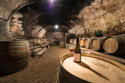 a bottle of wine on a table in a wine cellar at Glögglhof in Appiano sulla Strada del Vino