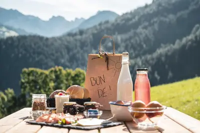 a picnic table with a bag and food on it at Batacör - Natures Heartbeat in San Vigilio Di Marebbe