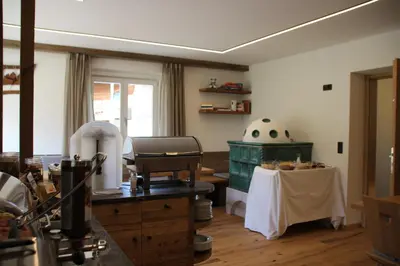 a kitchen with a table and a counter with a tableablish at Garni Bergblick in Braies