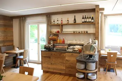 a kitchen with wooden cabinets and a counter with plates at Garni Bergblick in Braies