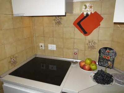 a kitchen with a bowl of fruit on a counter at Appartamento Panoramico Lungopassirio in Merano