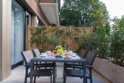 a table with a bowl of fruit on a patio at Apartment Hanni in Merano