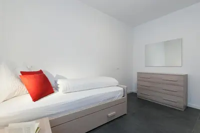 a bedroom with a bed and a dresser at Apartment Hanni in Merano