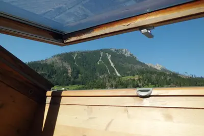 a window with a view of a mountain at Casa Venturini in Moena