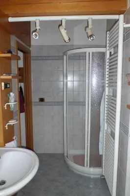 a bathroom with a shower and a sink at Casa Venturini in Moena