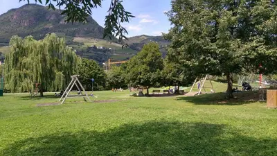 a park with a bunch of play equipment in the grass at Loft del Talvera 1 in Bolzano