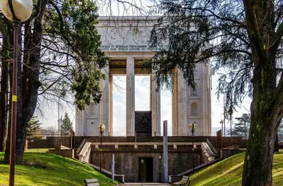 a large white building with columns in a park at Loft del Talvera 1 in Bolzano