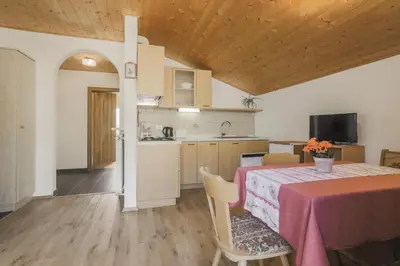 a bedroom with a large bed and a wooden ceiling at Traterhof-Spinges in Mühlbach