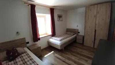 a living room with a bed and a window at Apartments Fabiola in Arabba