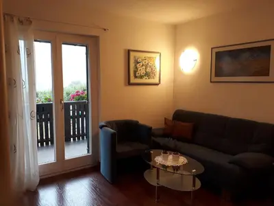 a living room with a couch and a table at GRETL - Residence in Parcines