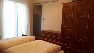 a bedroom with a bed and a cabinet and a dresser at GRETL - Residence in Parcines