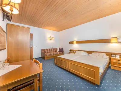 a hotel room with a bed and a sink at Hotel Pontives in Ortisei