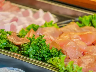 a tray of food with broccoli and meat at Hotel Pontives in Ortisei