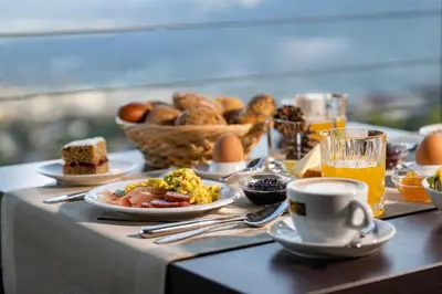 a breakfast table with breakfast foods and drinks on a table at Hotel Lechner in Tirolo
