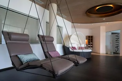 two chairs sitting in a room with a mirror at Hotel Lechner in Tirolo
