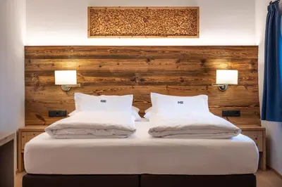 a bed with two white pillows on top of it at Ansitz Fonteklaus in Chiusa