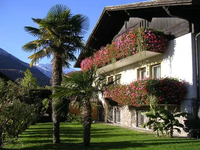 a building with flowers on the side of it at Oberangerhof in Lagundo