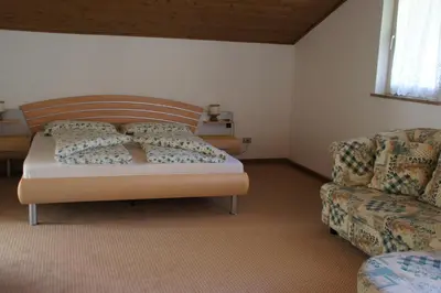 a bedroom with a bed and a couch at Oberangerhof in Lagundo