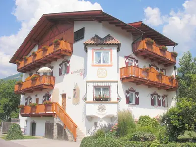 a building with balconies on the side of it at Garni Unterhaslerhof in Merano