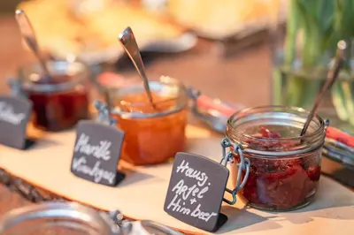 a table with jars of jam and signs on it at Apparthotel Calma in Cermes
