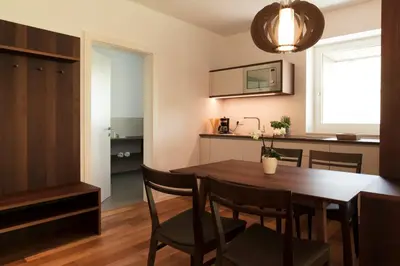 a kitchen and dining room with a table and chairs at Apparthotel Calma in Cermes