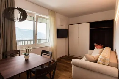 a living room with a table and a couch at Apparthotel Calma in Cermes
