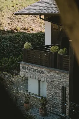 a building with a sign that reads reception at Hotel KÜGLERHOF in Tirolo
