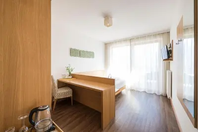 a kitchen with a wooden desk and a window at Residence Aqualis in Marlengo