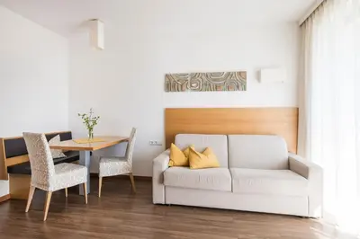 a living room with a couch and a table at Residence Aqualis in Marlengo