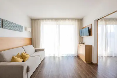 a living room with a couch and a television at Residence Aqualis in Marlengo