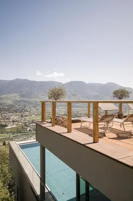 a balcony of a house with a swimming pool at Residence Aqualis in Marlengo